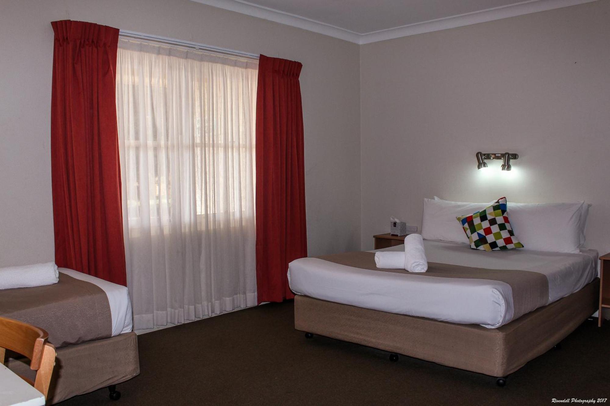 Downstairs Room with a Queen and 3 Single Beds